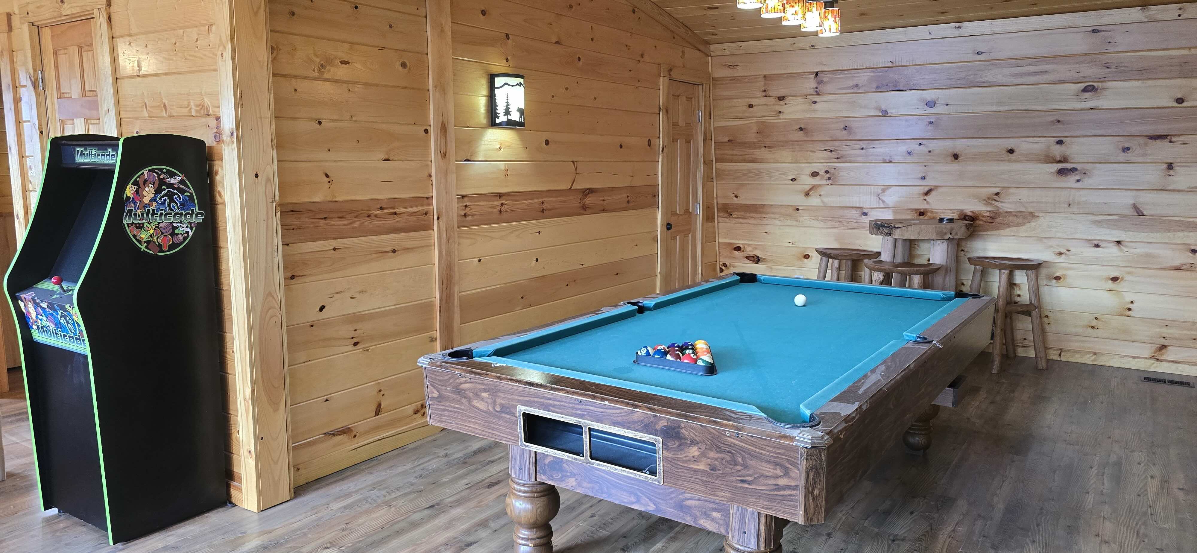 Pool table and multicade in the Honey Bear Lodge game room